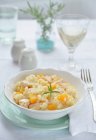 Risotto with roasted pumpkin and salmon over white table — Stock Photo