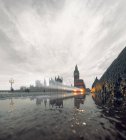 Westminster Bridge in rain with incoming double-decker bus, London, UK — Stock Photo