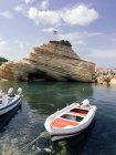 Scenic view of rocky coast and boats moored in foreground, Zakynthos, Greece — Stock Photo