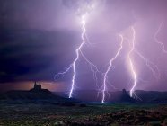 A lightning storm illuminating the north end of Utah Valley of the Gods, USA — Stock Photo