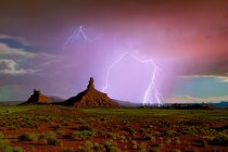 A depiction of a lightning storm moving through Utah Valley of the Gods, USA — Stock Photo
