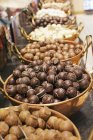 Selection of chocolate pralines and truffles in bowls — Stock Photo