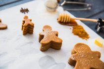 Stack of gingerbread men over table at kitchen — Stock Photo