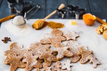 Gingerbread men cookies and ingredients at kitchen — Stock Photo