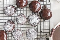 Lamington biscuits with coconut on a cooling rack — Stock Photo