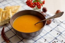 Pumpkin soup and homemade bread, closeup view — Stock Photo