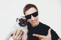 Portrait of a smiling man with his pug dog — Stock Photo