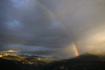 Scenic view of Rainbow over the mountains, switzerland — Stock Photo