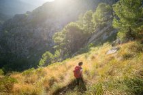 A young woman hiking in the backcountry of the Spanish island Mallorca. — Stock Photo