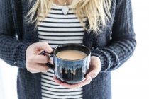Woman holding a cup of tea — Stock Photo