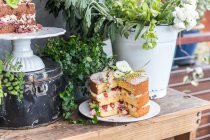 Triple layer victoria sponge cakes over wooden table — Stock Photo