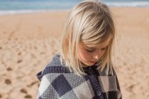 Close-up portrait of a girl standing on beach — Stock Photo