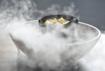 Coconut cake with dry ice in smoke — Stock Photo