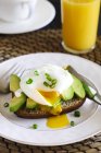 Toast with avocado and poached egg, closeup view — Stock Photo