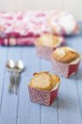 Drei leckere Cupcakes mit Zucker über dem Tisch — Stockfoto
