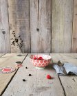 Bowl of muesli with raspberries over wooden table — Stock Photo