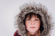 Portrait of serious girl in hooded parka — Stock Photo