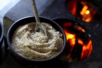 Close up view of Bowl of Farofa by a stove — стоковое фото