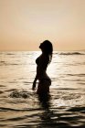 Silhouette of a woman standing in sea, Tarifa, Cadiz, Andalucia, Spain — Stock Photo