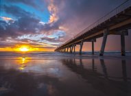 Scenic view of Pier reflection on beach at sunrise, Gold Coast, Queensland, Australia — Stock Photo