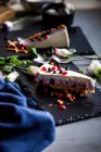 Slice of Blueberry cheesecake on black slate — Stock Photo