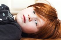 Portrait of a boy lying on floor — Stock Photo