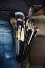 Close-up of make-up brushes in a womans make-up belt — Stock Photo