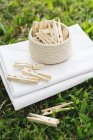Wooden clothes pegs on folded sheets on the grass — Stock Photo