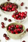 Closeup view of Bowls of cherries over white background — Stock Photo