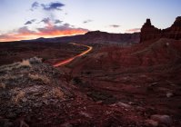 Straße durch die Wüste bei Sonnenuntergang, Hauptstadt-Riff-Nationalpark, utah, Amerika, USA — Stockfoto