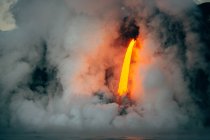 Lava flowing from a lava tube into Pacific ocean, Hawaii, America, USA — Stock Photo