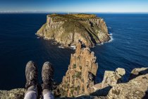 Cropped image of woman sitting on The Blade, Cape Pillar, Tasmania, Australia — Stock Photo