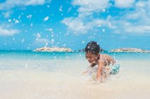 Boy playing in the sea — Stock Photo