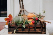 Rustic wooden box filled with pumpkins — Stock Photo