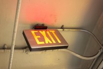 Closeup view of Illuminated Exit sign in a building — Stock Photo