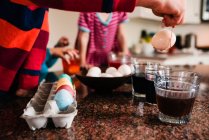Young children dying Easter eggs — Stock Photo