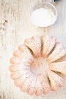 Homemade cake with powdered sugar on white background — Stock Photo