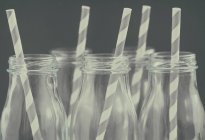 Glasses with striped straws, close up shot — Stock Photo