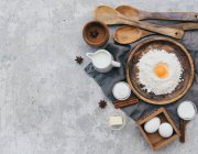 Ingredients for baking. homemade eggs, flour, butter, whisk, milk, dough, top view, — Stock Photo