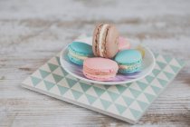 Colorful macaroons on a wooden background — Stock Photo