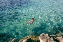 Girl snorkeling in sea blue water — Stock Photo