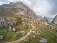Woman Mountain Biking in the Dolomites, Val Gardena, South Tyrol, Italy — стокове фото