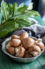 Fresh mushrooms and bay leaves on a kitchen worktop — Stock Photo