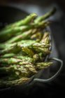 Asparagus in a colander in a sink, closeup view — Stock Photo