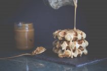 Belgian waffles with hot toffee cream sauce — Stock Photo