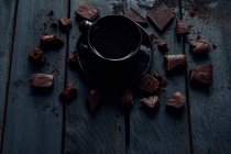Cup of coffee with dark chocolate, closeup view — Stock Photo