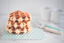 Stack of Belgian waffles on napkins — Stock Photo