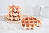 Stack of Belgian waffles on napkins — Stock Photo