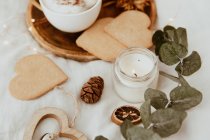 Coffee, cookies and a candle on a bed — Stock Photo