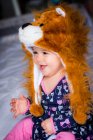 Portrait of a smiling baby girl wearing an animal hat — Stock Photo
